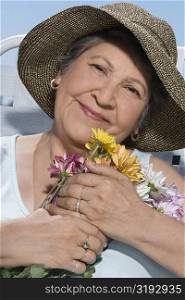 Senior woman holding bunch of flowers