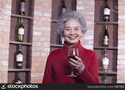 Senior Woman Holding Glass of Wine, Portrait