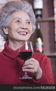 Senior Woman Holding Glass of Wine, Portrait