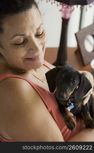 Senior woman holding small dog
