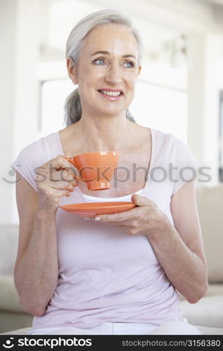 Senior Woman Holding Tea And Smiling At The Camera