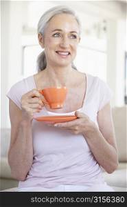 Senior Woman Holding Tea And Smiling At The Camera