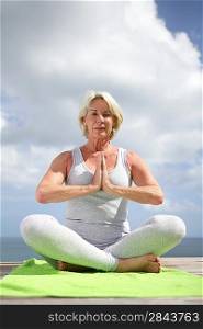 Senior woman in a yoga position