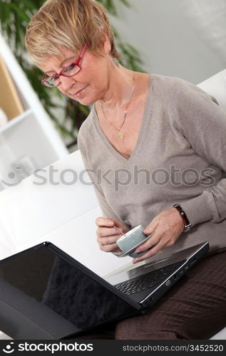 Senior woman in front of a laptop at home