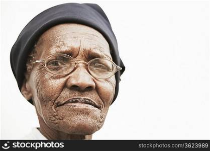 Senior woman in hat and spectacles