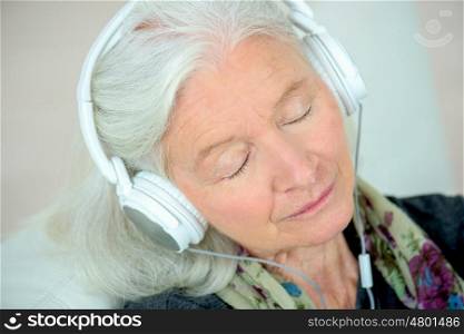 senior woman in headphones