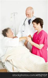 Senior woman in hospital, with her doctor and her nurse.