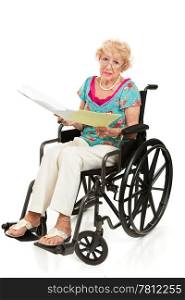 Senior woman in wheelchair holding a stack of bills. Full body isolated on white.