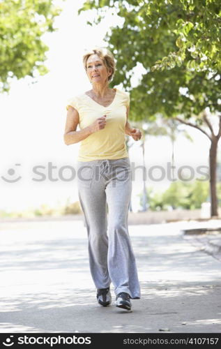 Senior Woman Jogging In Park