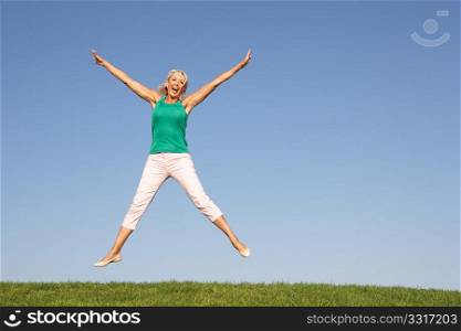 Senior woman jumping in air