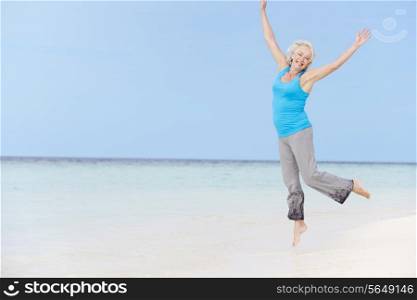 Senior Woman Jumping On Beautiful Beach