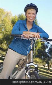 Senior woman leaning on bicycle, portrait