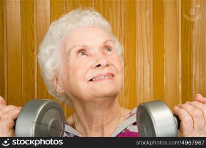 Senior woman lifting dumbbells
