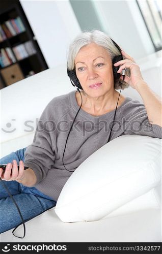 Senior woman listening to music with headphones