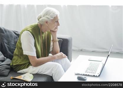 senior woman looking laptop with concentration