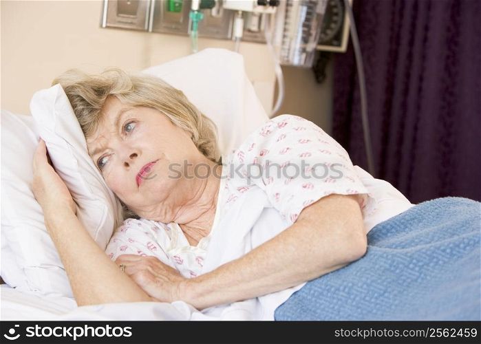 Senior Woman Lying In Hospital Bed