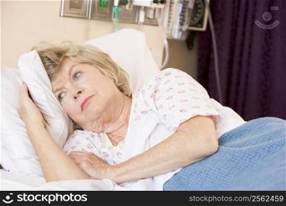 Senior Woman Lying In Hospital Bed