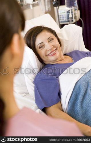 Senior Woman Lying In Hospital Bed,Smiling