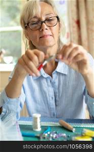 Senior Woman Making Jewellery Earrings At Home
