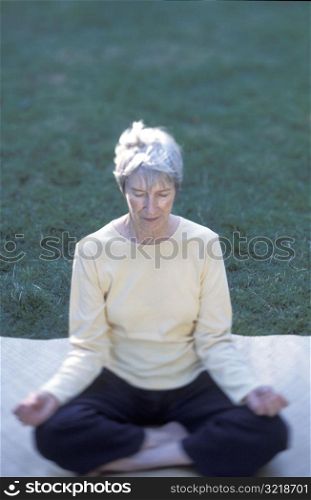 Senior Woman Meditating Outside