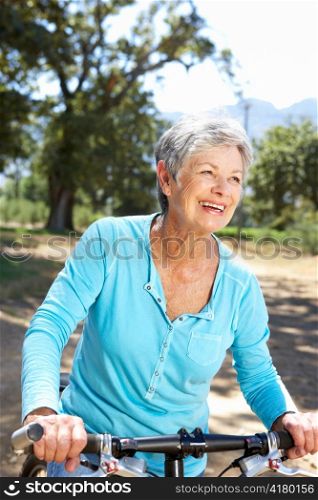 Senior woman on country bike ride