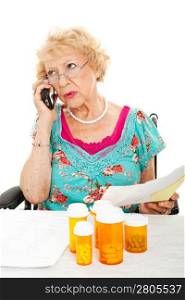 Senior woman on the phone discussing her medical bills with the health insurance company. White background.