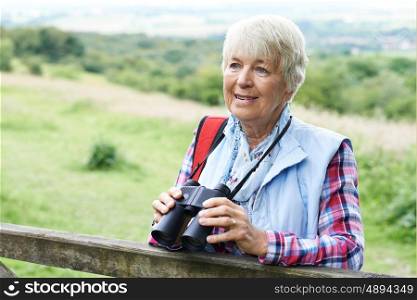 Senior Woman On Walk With Binoculars