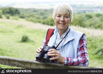 Senior Woman On Walk With Binoculars