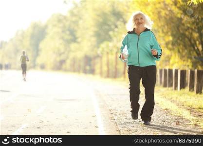 Senior Woman Outdoors in the Bright Autumn Evening