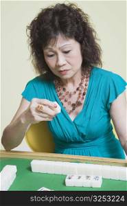 Senior woman playing mahjong