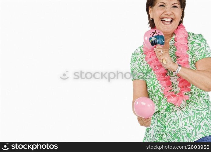 Senior woman playing maracas and smiling