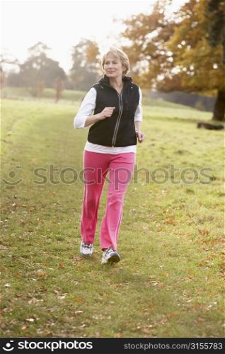 Senior Woman Power Walking In The Park