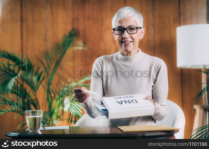 Senior Woman Preparing DNA Genetic Test Kit