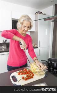 Senior woman preparing food at kitchen counter