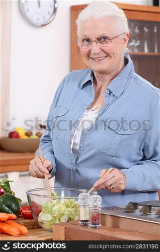 Senior woman preparing salad