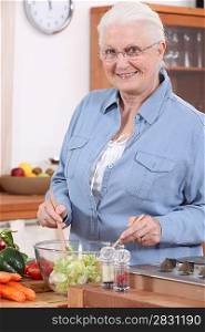 Senior woman preparing salad