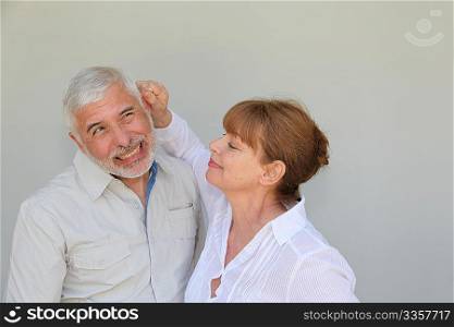 Senior woman pulling on husband&acute;s ear