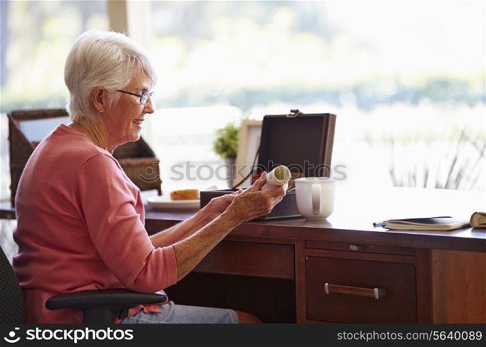 Senior Woman Putting Will Into Box