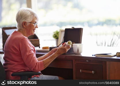 Senior Woman Putting Will Into Box