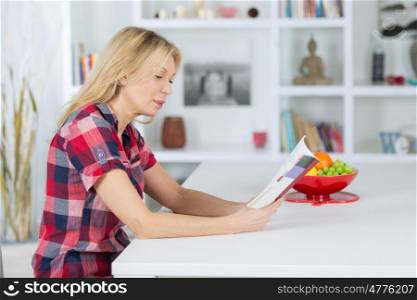 senior woman reading a book at homerelaxing time