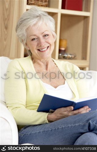 Senior Woman Reading Book At Home