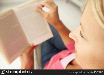 Senior woman reading book at home