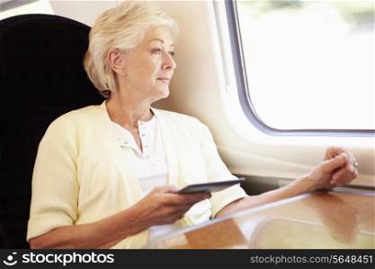 Senior Woman Reading E Book On Train Journey