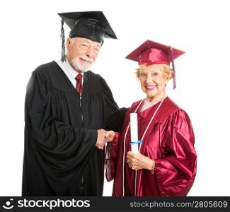 Senior woman receives her diploma at graduation ceremony. Isolated on white.