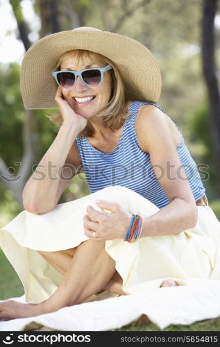 Senior Woman Relaxing In Summer Garden