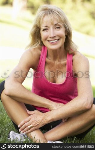 Senior Woman Resting After Exercising In Park