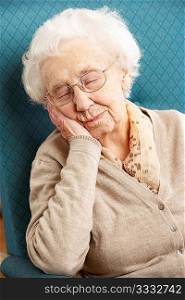 Senior Woman Resting In Chair At Home