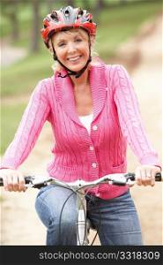 Senior woman riding bicycle in park