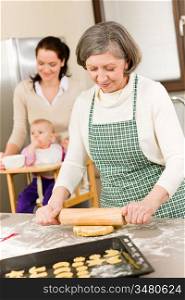 Senior woman rolling dough prepare for baking cookies in kitchen