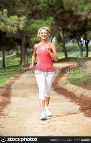 Senior woman running in park